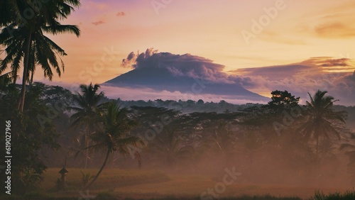 Stunning view of Mount Agung, in Bali, illuminated by a vibrant sunset