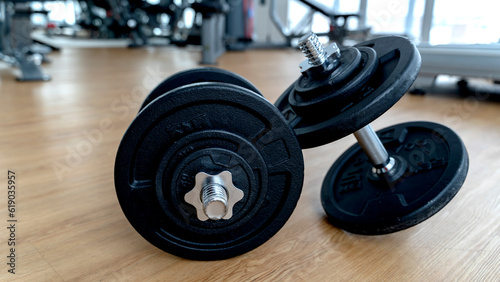 dumbbells in the gym on the floor, the concept of proper nutrition and fitness, a place for the inscription