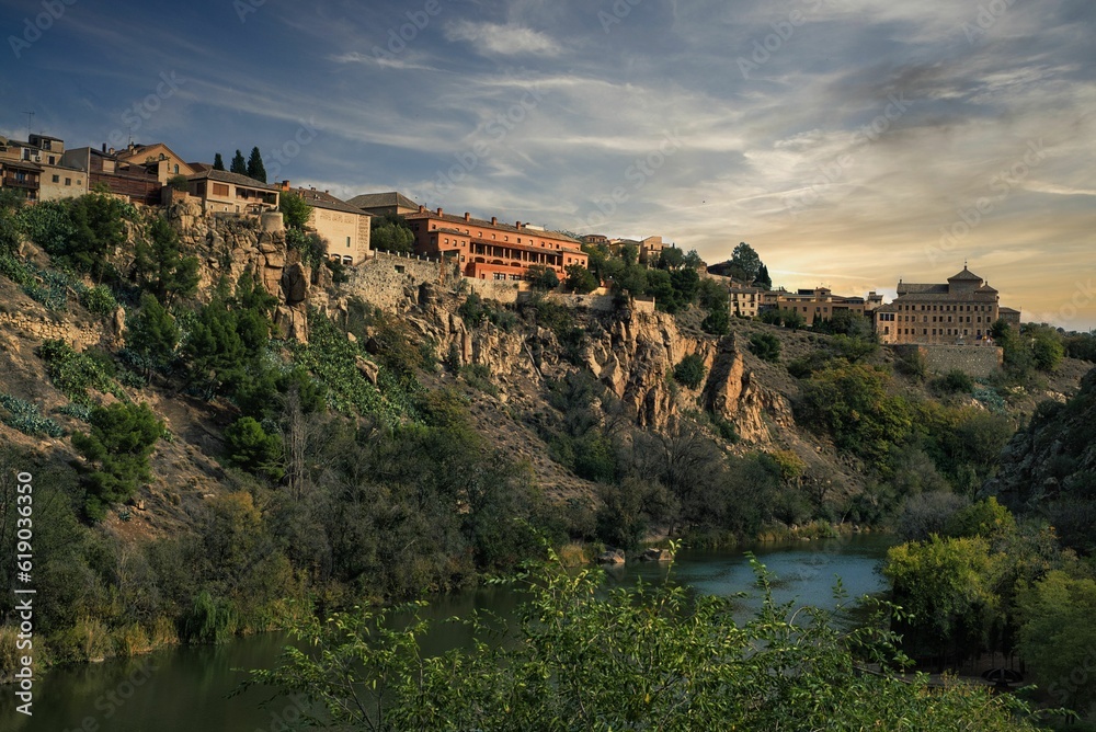 Bustling cityscape of modern buildings situated on the edge of a deep canyon in Toledo, Spain