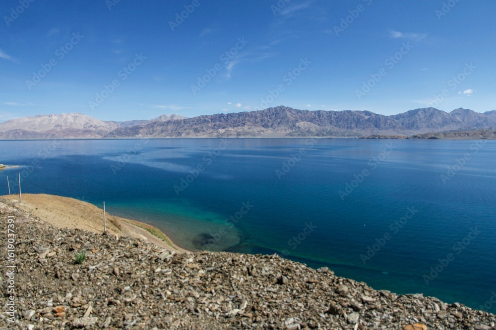 Stunning landscape featuring a serene lake with a rocky shoreline