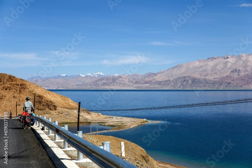 Wallpaper Mural Group of people standing on the side of a scenic highway overlooking a large lake Torontodigital.ca