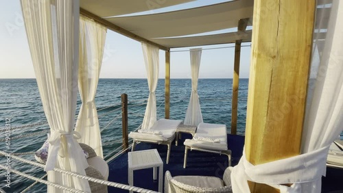 Scenic view of white luxury sun loungers on the boat in the sea photo