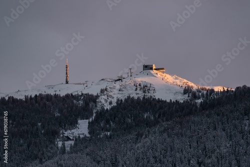 Landscape of Kronplatz covered in snow under a cloudy sky during the sunrise photo