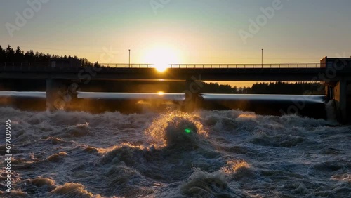 Wallpaper Mural Beautiful view of water waves splashing under a silhouette bridge and trees at sunset Torontodigital.ca
