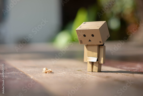 Valokuvatapetti Small wooden toy robot danbo lonely isolated alone sad character, wood floor out