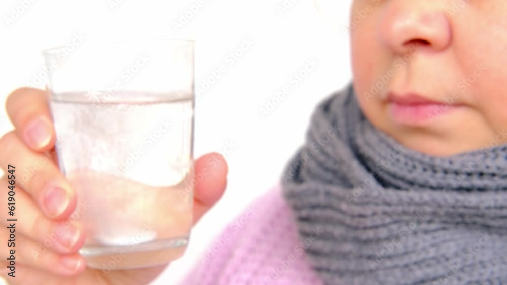 close-up of mature charismatic woman 50 years drinks clean water with effervescent tablet from glass, takes pill, concept most important element for life, human health, quench thirst close-up of mature charismatic woman 50 years drinks clean water with effervescent tablet from glass, takes pill, concept most important element for life, human health, quench thirst