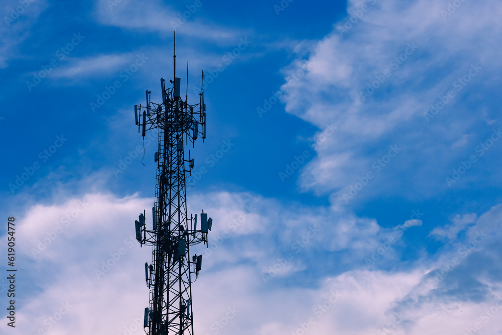 Microwave transmission tower on the background of water logged clouds in the sky