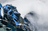 The ridge of the highest Austrian mountain Grossglockner and the Erzherzog Johann Hut in clouds. 