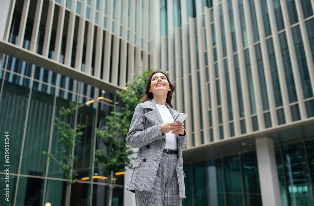Young Businesswoman Using Smartphone Texting Standing Outdoor Of Office Building
