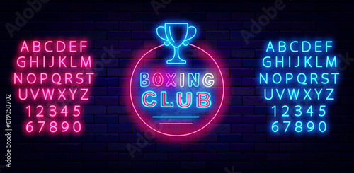 Boxing club neon label with winner cup. Power sport. Glowing sign on brick wall. Vector stock illustration