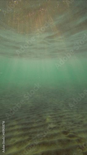 Low angle wide shot sun rays penetrating surface of water in the morning time, Underwater light creates beautiful veil, consisting of sunlight in the morning time, Red sea, Egypt