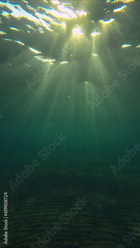 Low angle wide shot sun rays penetrating surface of water in the morning time, Underwater light creates beautiful veil, consisting of sunlight in the morning time, Red sea, Egypt