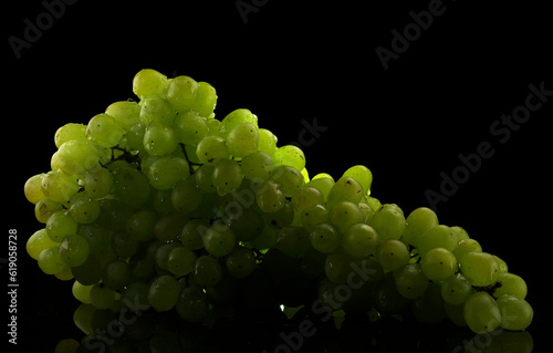 White grapes with drops of water, isolated on black background