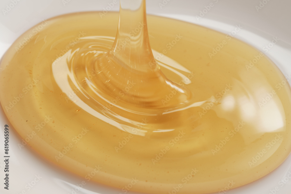 Closeup shot of organic honey pouring in bowl