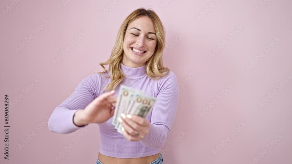 Young beautiful hispanic woman smiling confident throwing dollars over isolated pink background Young beautiful hispanic woman smiling confident throwing dollars over isolated pink background