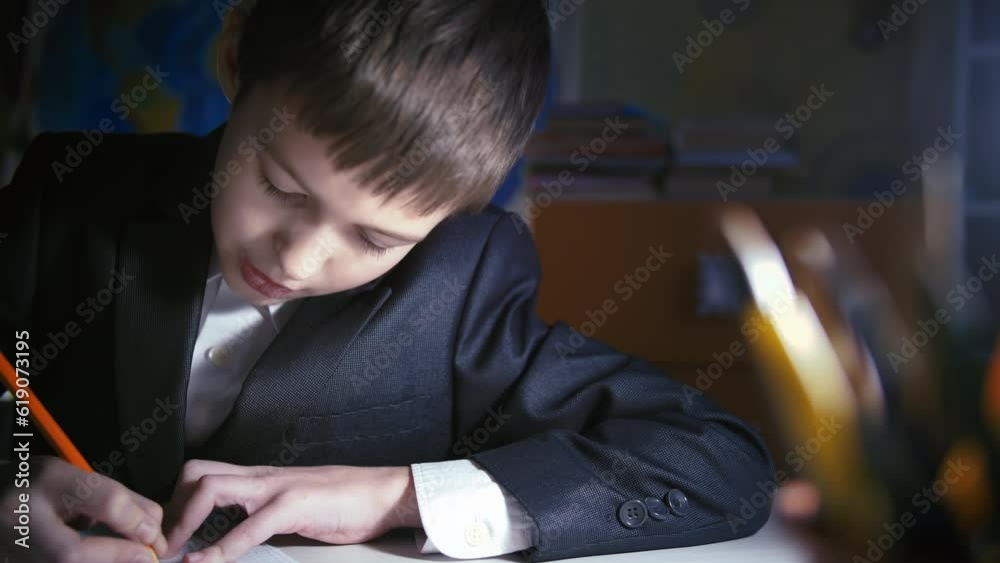Evening Study Session: Boy Engaged in Homework at Home Evening Study Session: Boy Engaged in Homework at Home