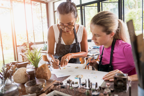 Teacher jeweler and student make jewelry in workshop