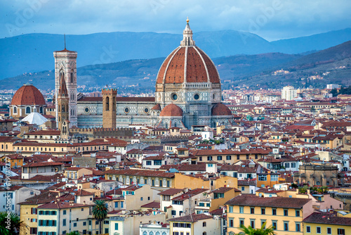 panoramic view of Firenze (Florence) at sunset, taken from Piazzale Michelangelo. historical landmarks, including the iconic Duomo and Palazzo Vechio, can be seen at a distance