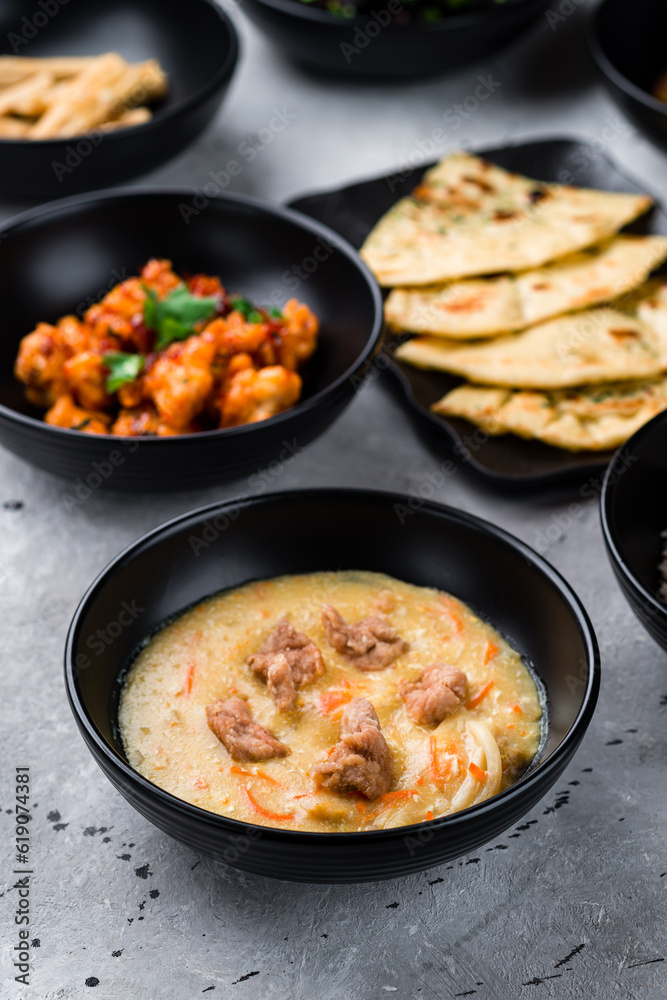 Soup with noodles and chicken, spicy chicken fillet with chili and Naan flatbread with cilantro. Soup with noodles and chicken, spicy chicken fillet with chili and Naan flatbread with cilantro.