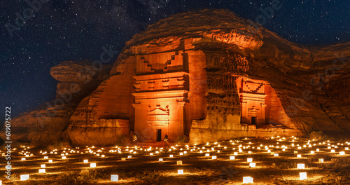 Guarded ancient tombs of nabataean Hegra Mada'in Salih city illuminated during the night, Al Ula, Saudi Arabia