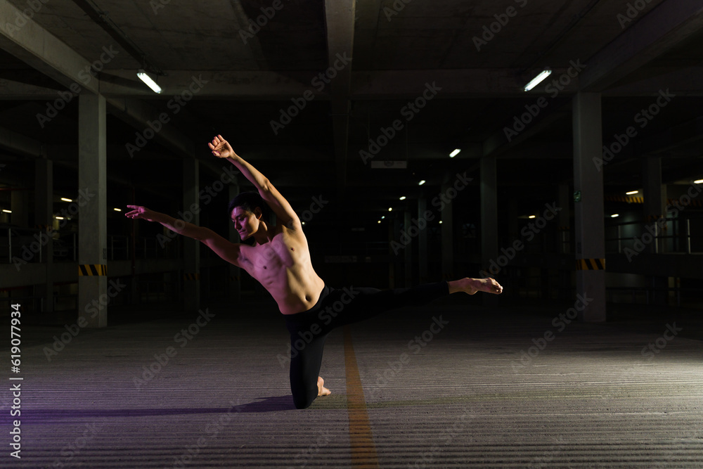 Attractive urban performer dancing a dramatic dance