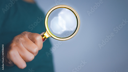 Businessman using magnifying glass searching data. Information in the internet world search technology Search Engine Optimization(SEO).