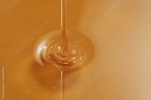 Closeup shot of organic honey pouring in bowl