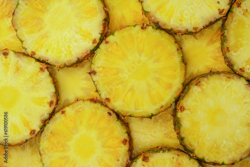 Pineapple juicy yellow slices as a background.