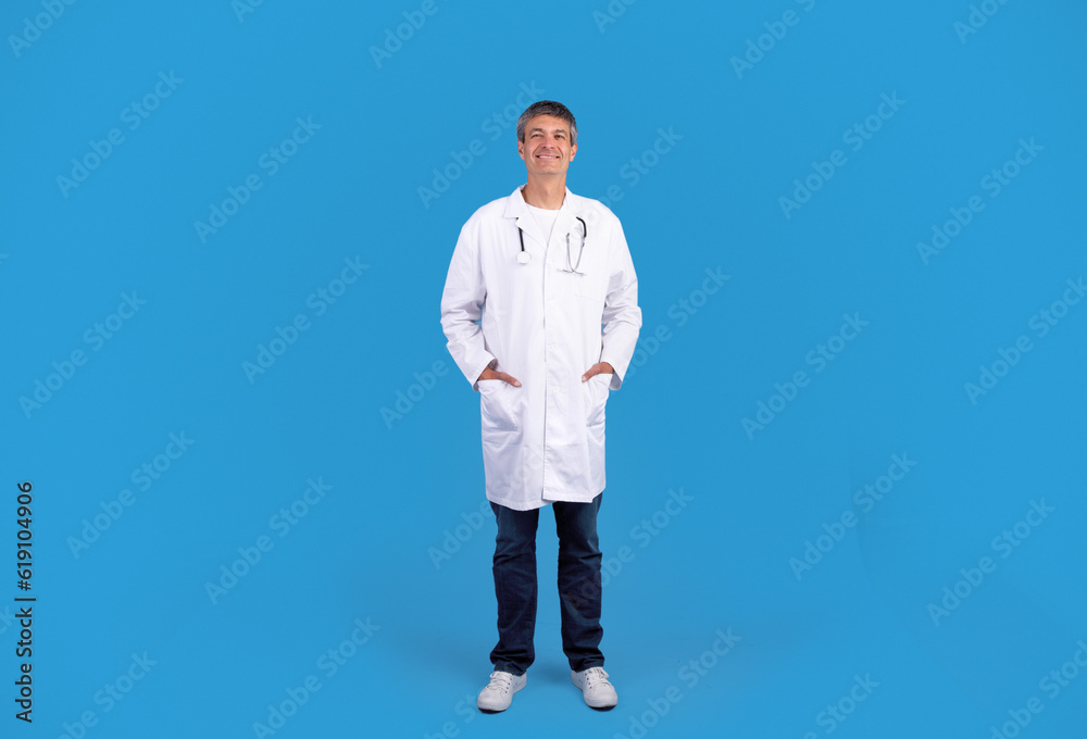 Full Length Of Smiling Doctor Man Posing On Blue Background Full Length Of Smiling Doctor Man Posing On Blue Background