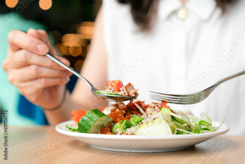 Woman eating green healthy tasty eco salad.  Diet food