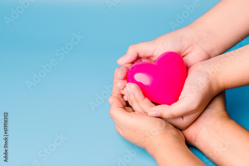 foster home concept. hands holding red heart  health care  love  organ donation  mindfulness  wellbeing  family insurance and CSR concept  world heart day  world health day  world mental health day.