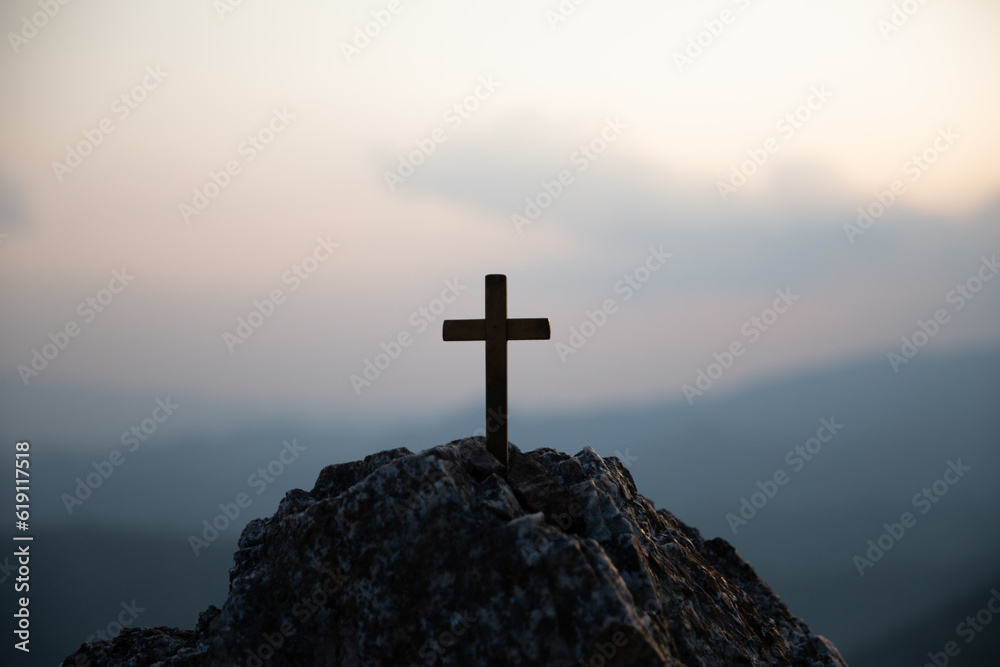 Crucifixion Of Jesus Christ - Cross At Sunset. Silhouette cross on Calvary mountain sunset background. Easter concept
