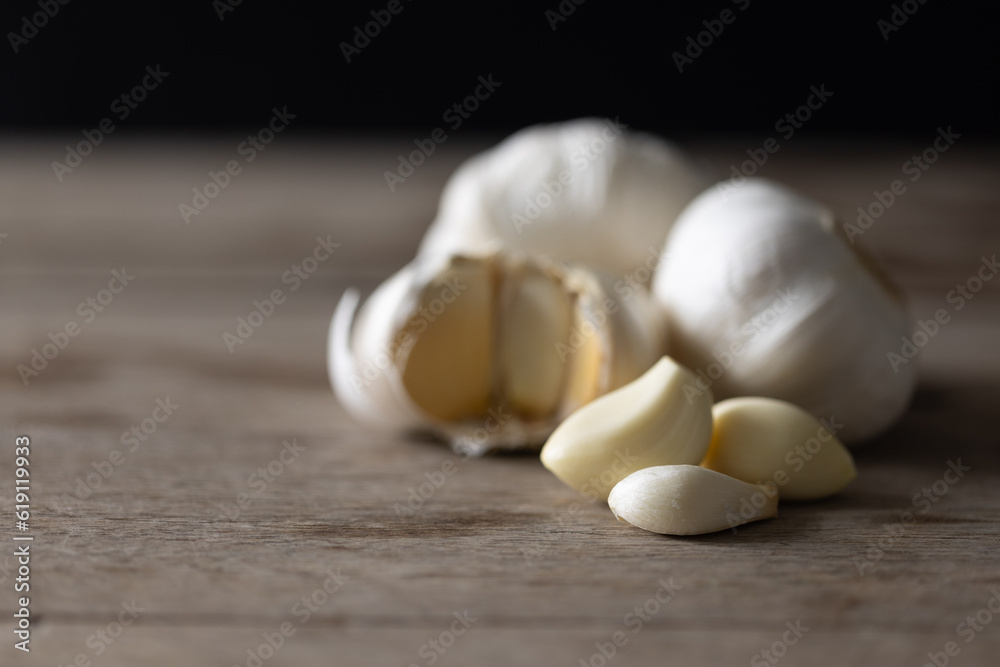 Seasoned Garlic and Herbs for Delicious Home Cooking. Fresh garlic and a variety of aromatic herbs are beautifully arranged on a wooden table, evoking the natural flavors and fragrances. Seasoned Garlic and Herbs for Delicious Home Cooking. Fresh garlic and a variety of aromatic herbs are beautifully arranged on a wooden table, evoking the natural flavors and fragrances.