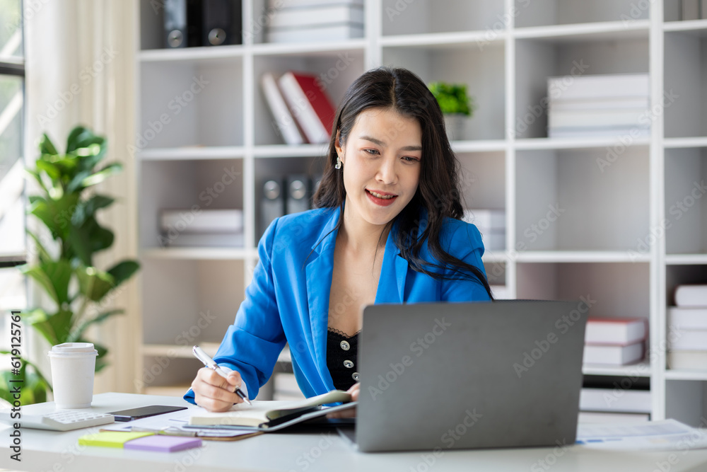 Young beautiful asian woman working in corporate office, businesswoman working in office attentively to grow and modernize start-up business, she is analyzing company's market and financial data.