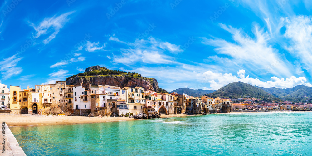 Cefalu, medieval town on Sicily island, Italy. Seashore village with beach and clear turquoise water of Tyrrhenian sea, surrounded with mountains. Popular tourist attraction in Province of Palermo