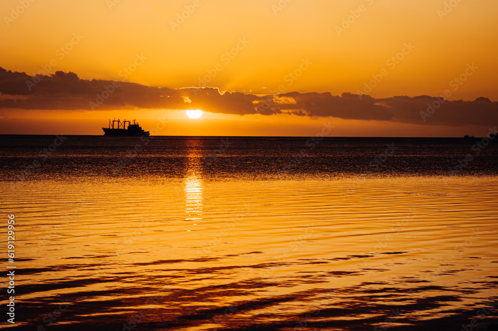 Sunset over fishing boats and commercial tankers, Tombeau Bay, Mauritius