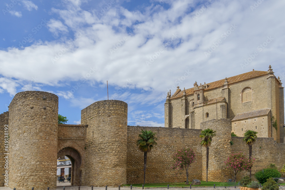 defensive walls of the city of ronda ,almocabar gate and church of the espiritu santo in ronda ,malaga,spain