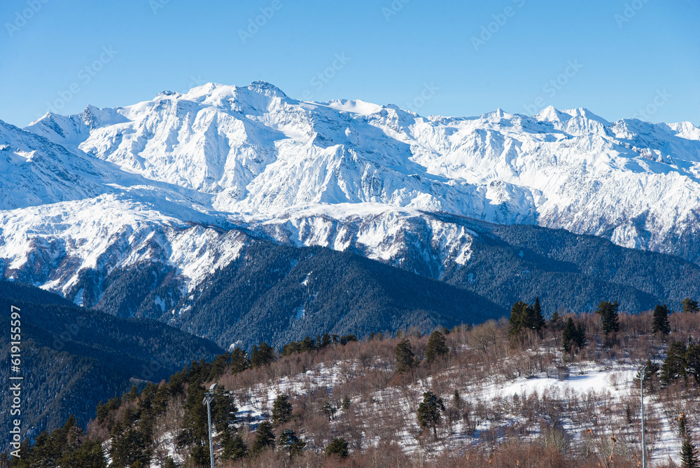 Beautiful nature lanscape with Caucasus mountain and pine forest covered with snow in winter. Cable car at Hatsvali ski resort Mestia Georgia