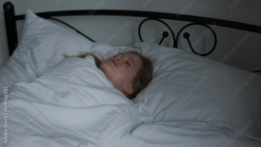 Hard awakening. Adorable girl trying to wake up in morning, sitting in bed but falling down, tracking shot, free space Hard awakening. Adorable girl trying to wake up in morning, sitting in bed but falling down, tracking shot, free space