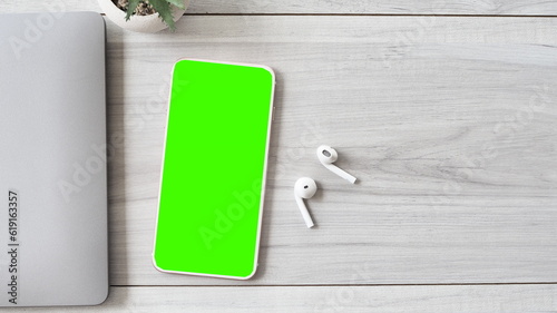 Quadro su tela Phone mobile telephone with a vertical green screen technology cell phone on whi
