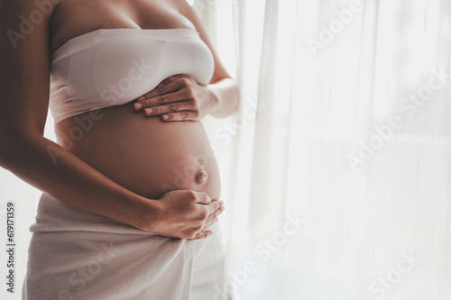 Free Download Concept Maternity and Pregnant, Prenatal care and pregnancy. Love of family, motherhood. Pregnant woman is holdings belly and enjoying the care of her child in the morning. - GFXLoad