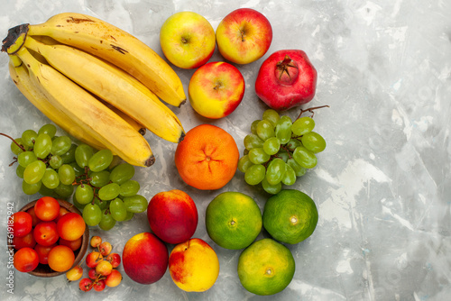 top view fresh yellow bananas mellow and delicious fruits with grapes apples on light white desk fruit fresh mellow tropical