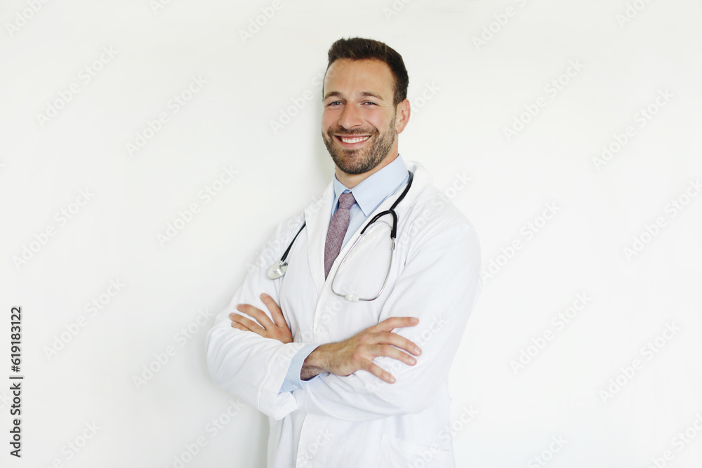Professional general practitioner. Portrait of cheerful man doctor posing with folded arms and smiling on white studio wall background Professional general practitioner. Portrait of cheerful man doctor posing with folded arms and smiling on white studio wall background