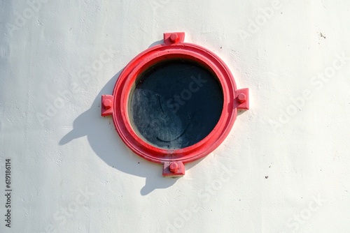 A round window with red edges. Lighthouse on the Estonian island of Kihnu photo