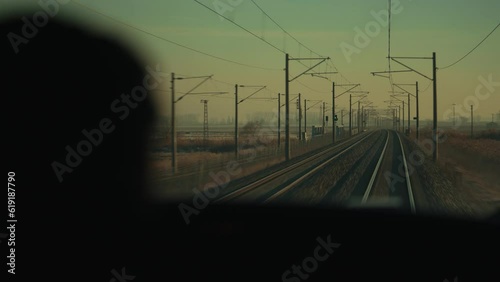 4K action cam footage from moving train on railway in sepia tinted daylight against Mexican rural background. Railway tracks seen from locomotive driver perspective POV stock video.
