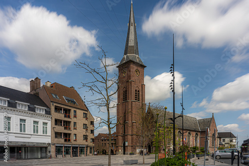 Marketplace of the city Moeskroen, Mouscron België.  Blue sky and church. photo