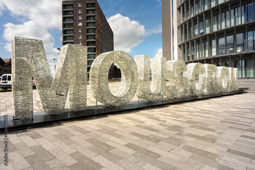 A big sign with the name of the city Mouscron, Moeskroen België.   photo