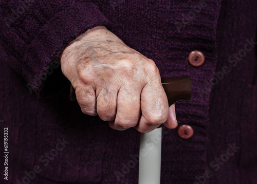 Hand of an elderly woman on a cane