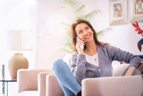 Confident woman wearing casual clothes and having a call at home