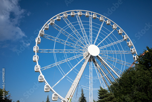 ferris wheel ride in amusement park on blue sky background. High quality photo